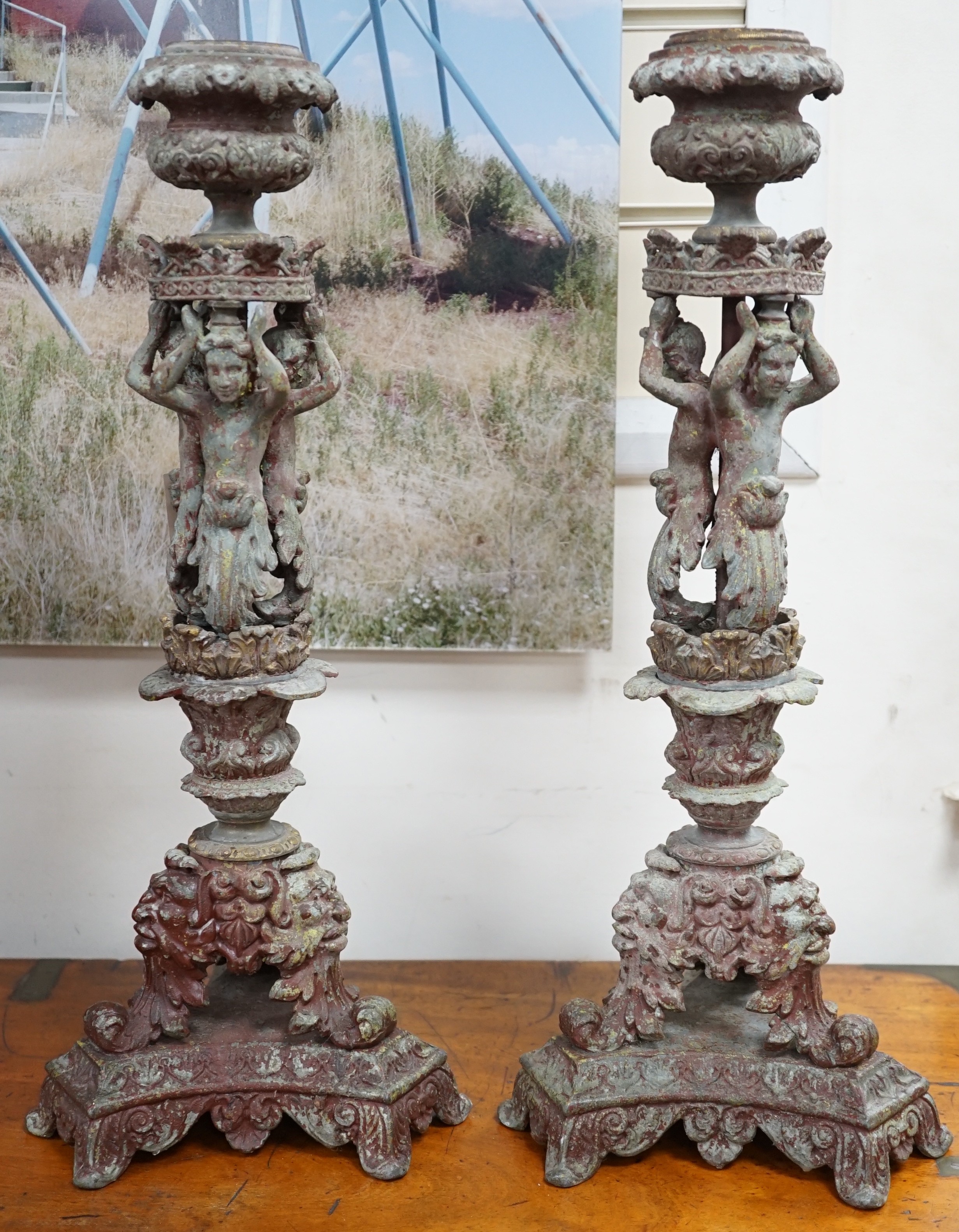 A pair French cast metal candlesticks. 47cm tall